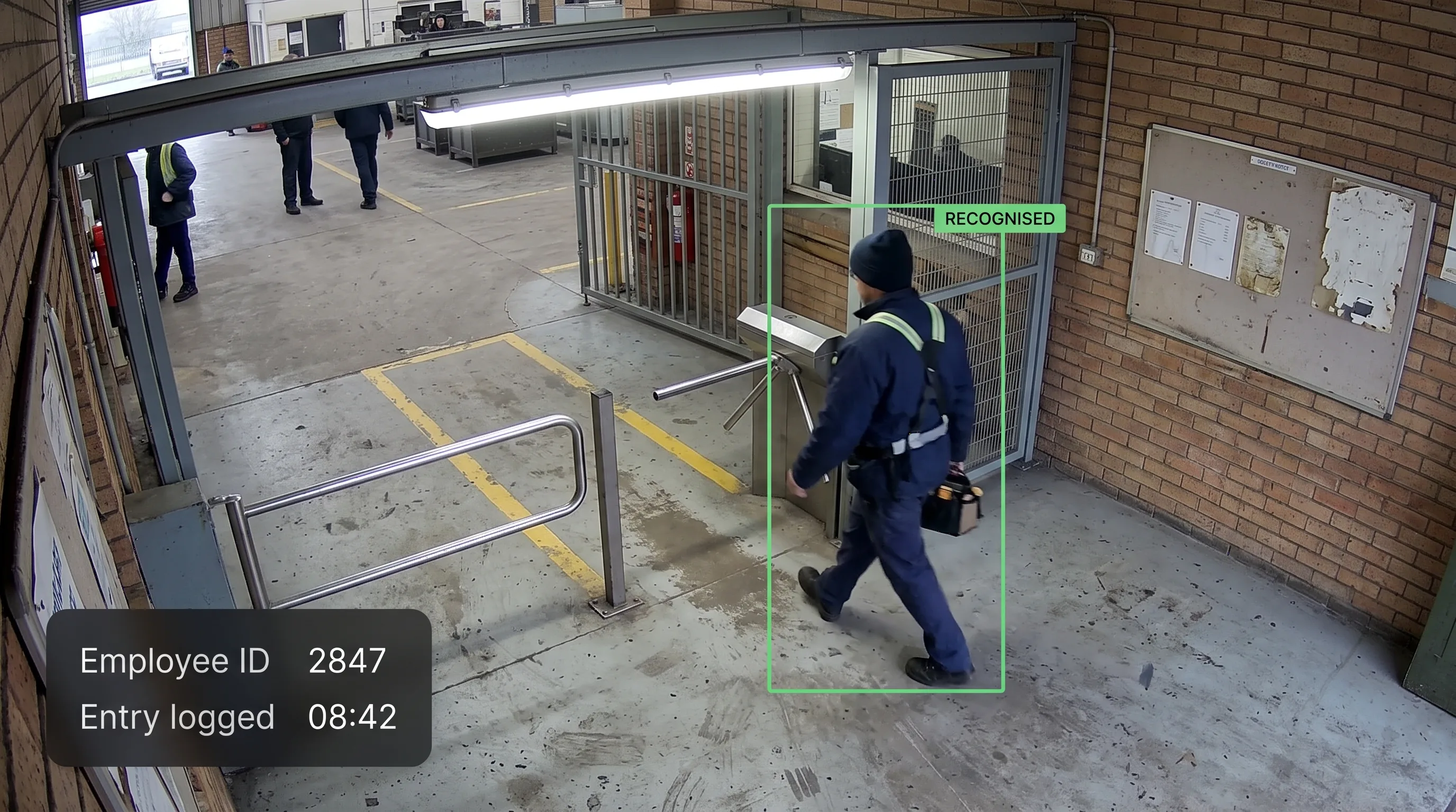 AI face attendance recognising an employee walking through a factory gate on an existing CCTV camera, with entry logged automatically